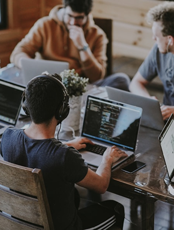 A software team working together on laptops